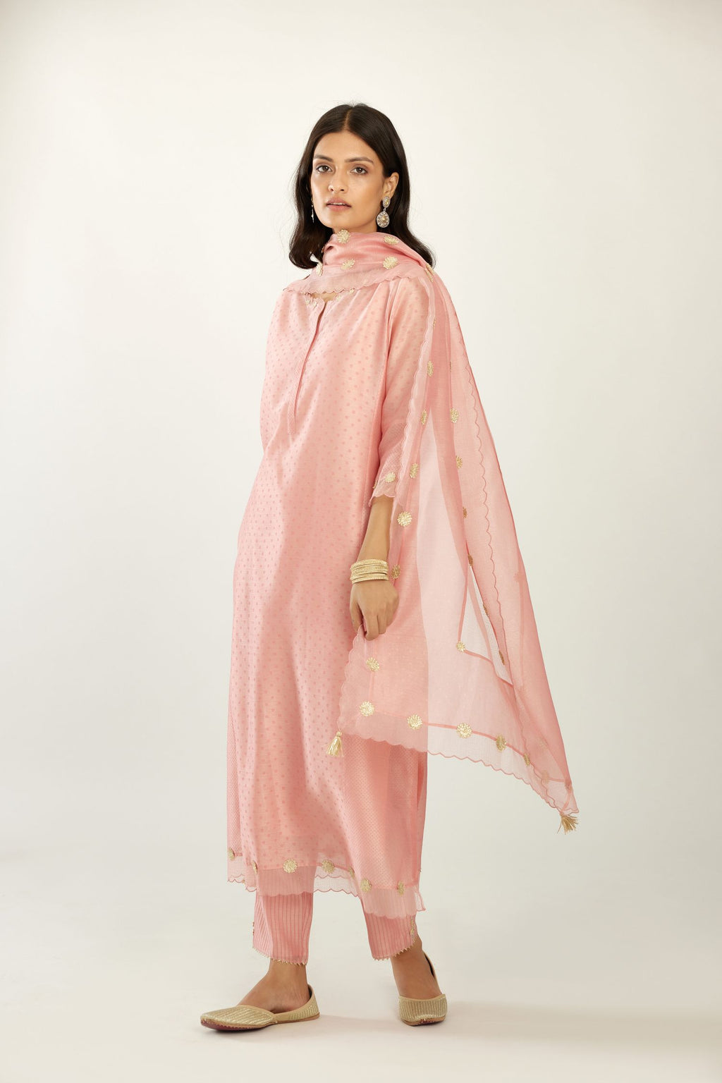 Pink hand block printed silk chanderi kurta set with concealed button placket neckline, Highlighted with gota flower and scalloped organza at edges.