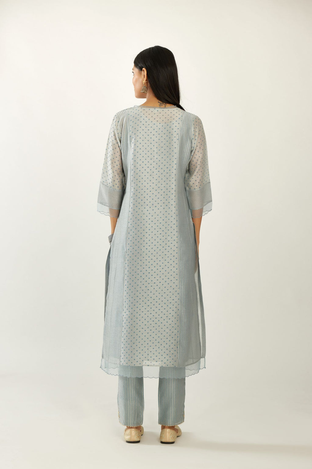 Blue silk chanderi hand block printed straight kurta set with concealed button placket neckline, highlighted with scalloped organza at edges.