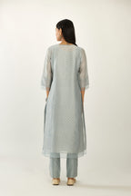 Blue silk chanderi hand block printed straight kurta set with concealed button placket neckline, highlighted with scalloped organza at edges.