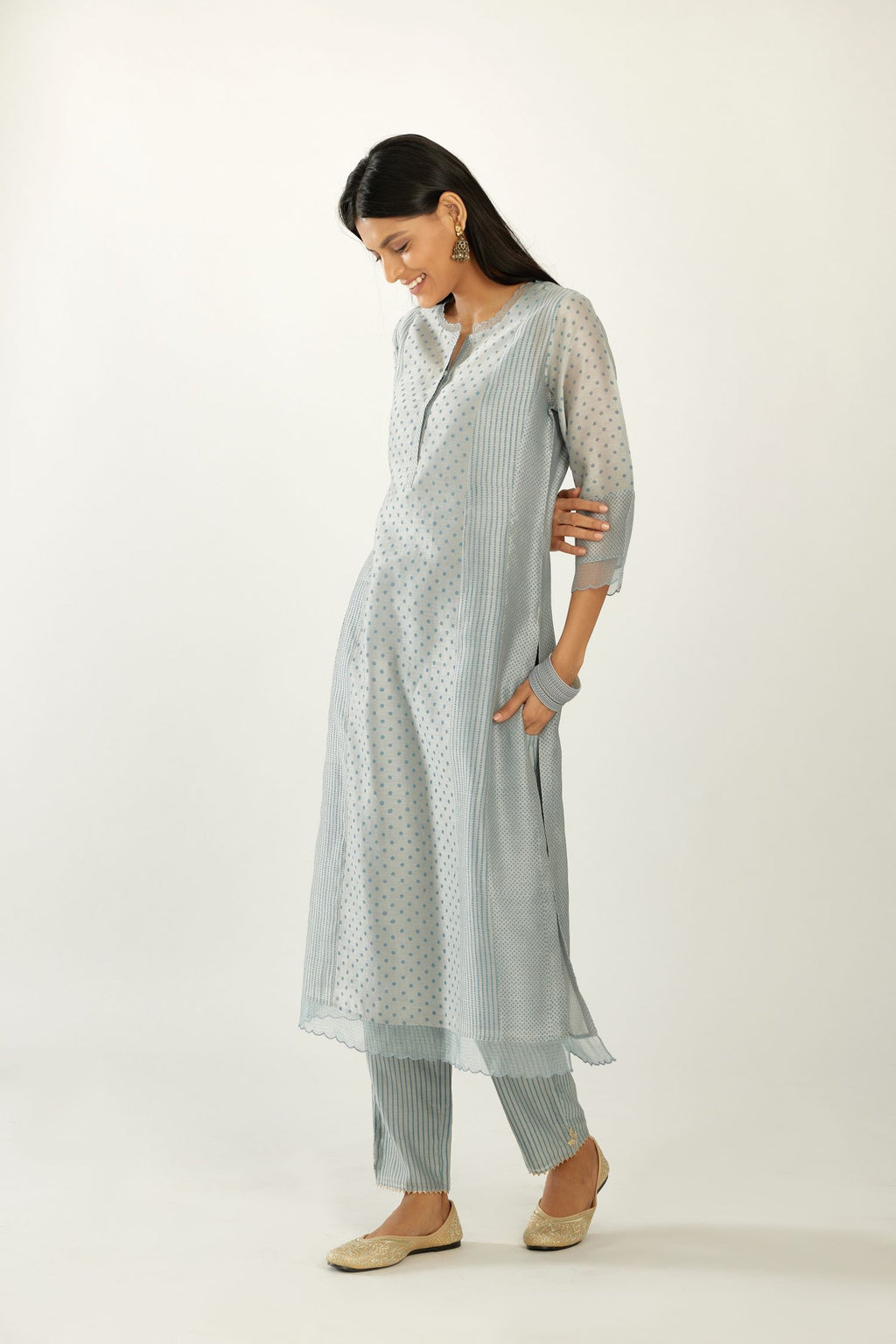 Blue silk chanderi hand block printed straight kurta set with concealed button placket neckline, highlighted with scalloped organza at edges.