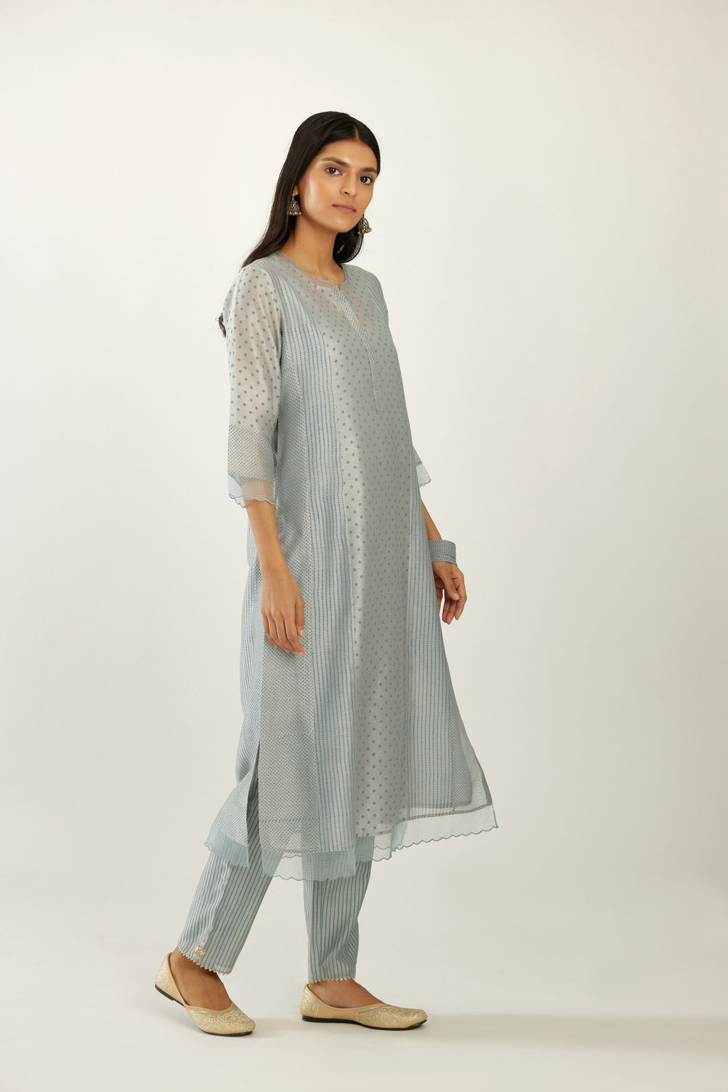 Blue silk chanderi hand block printed straight kurta set with concealed button placket neckline, highlighted with scalloped organza at edges.