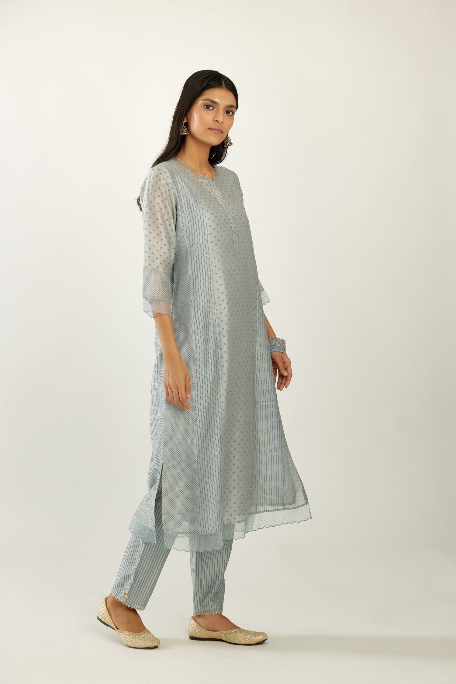 Blue silk chanderi hand block printed straight kurta set with concealed button placket neckline, highlighted with scalloped organza at edges.