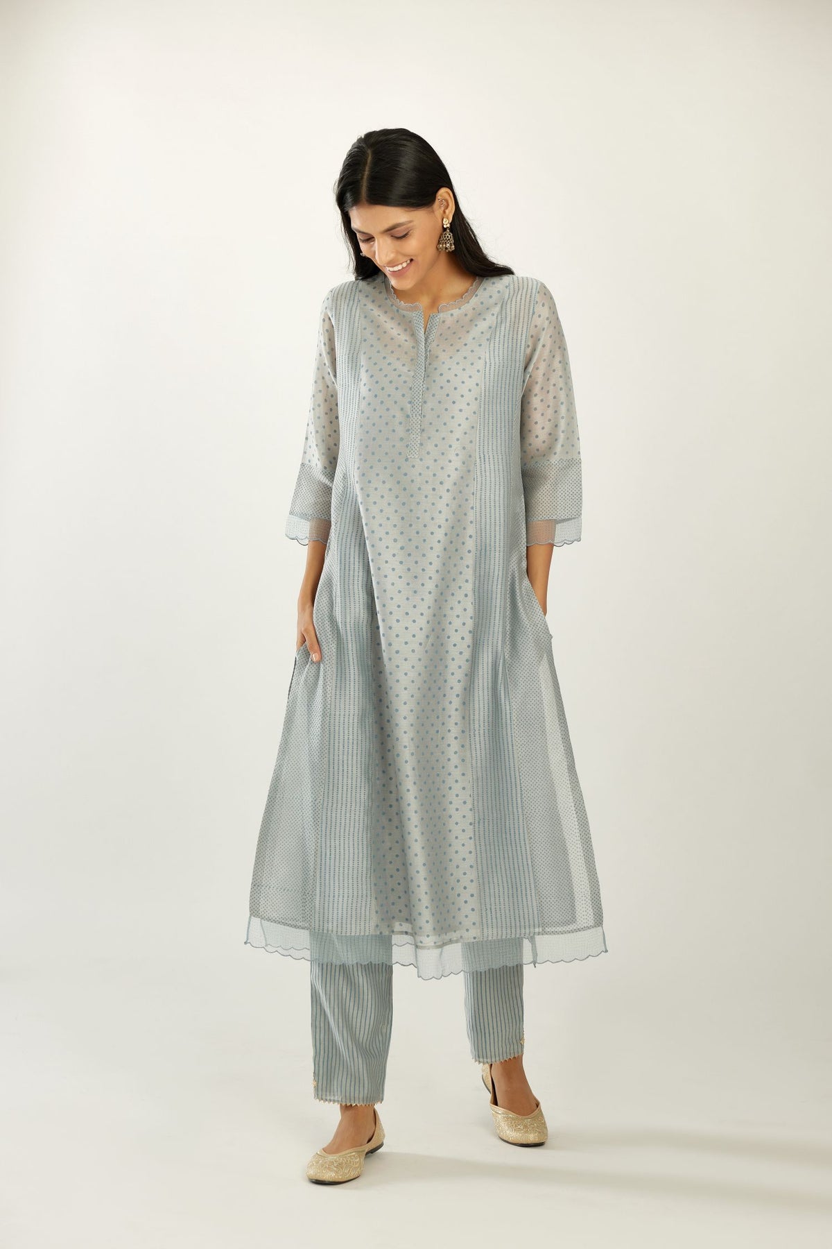 Blue silk chanderi hand block printed straight kurta set with concealed button placket neckline, highlighted with scalloped organza at edges.