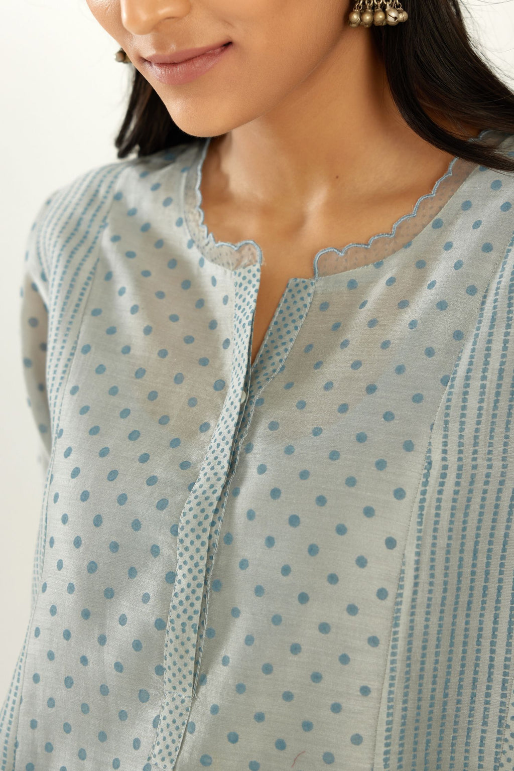 Blue silk chanderi hand block printed straight kurta set with concealed button placket neckline, highlighted with scalloped organza at edges.