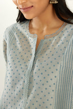Blue silk chanderi hand block printed straight kurta set with concealed button placket neckline, highlighted with scalloped organza at edges.