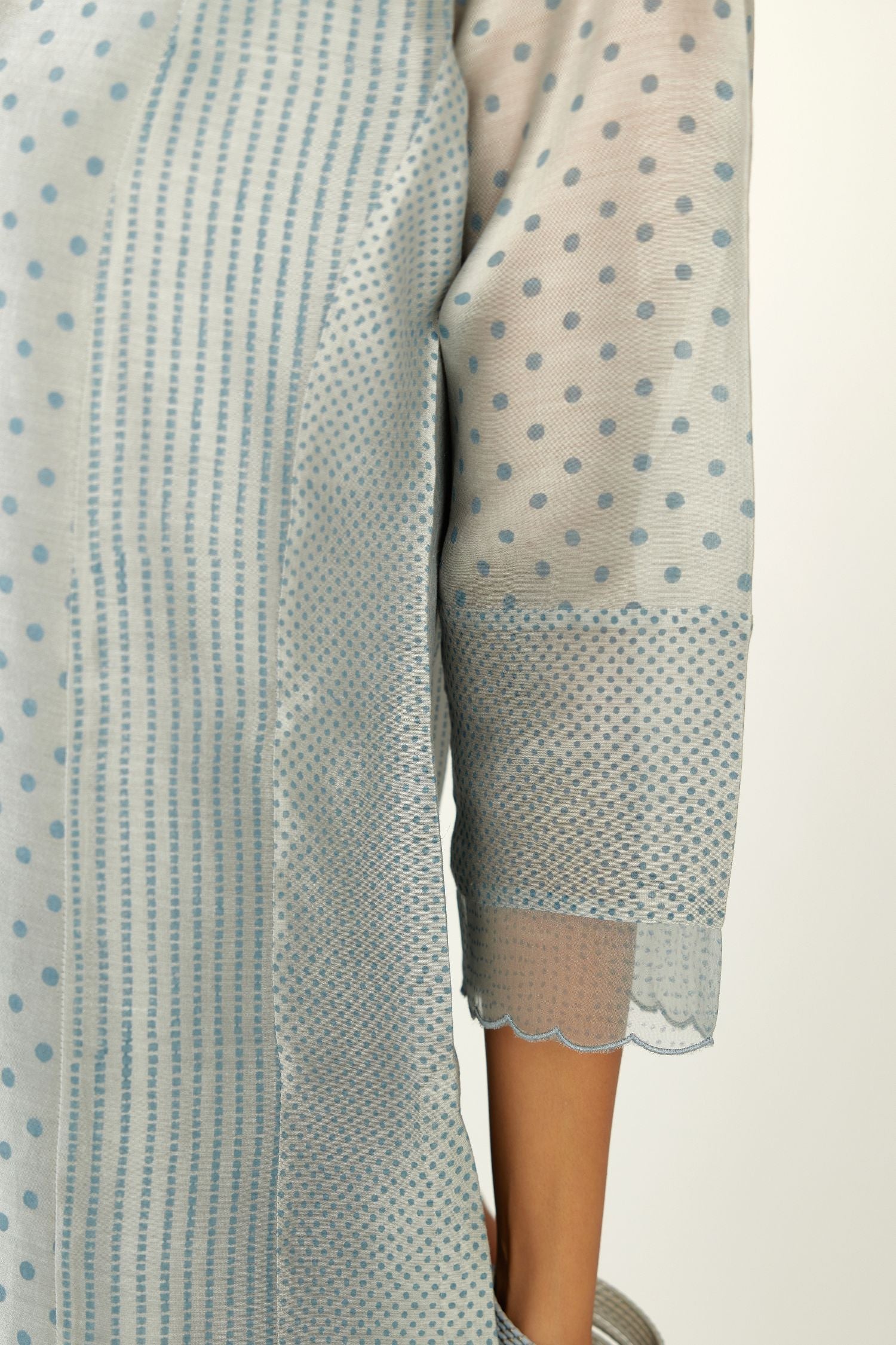 Blue silk chanderi hand block printed straight kurta set with concealed button placket neckline, highlighted with scalloped organza at edges.