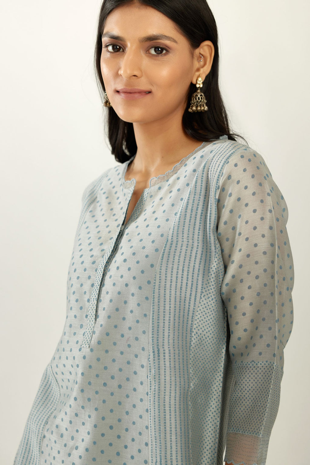Blue silk chanderi hand block printed straight kurta set with concealed button placket neckline, highlighted with scalloped organza at edges.