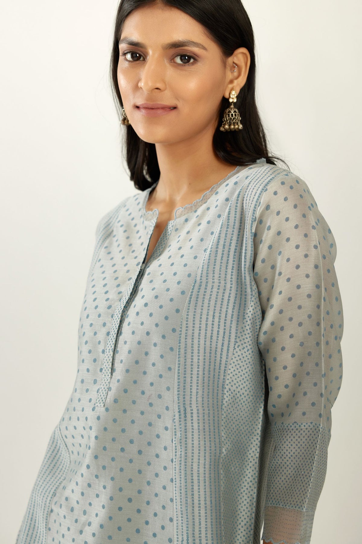 Blue silk chanderi hand block printed straight kurta set with concealed button placket neckline, highlighted with scalloped organza at edges.