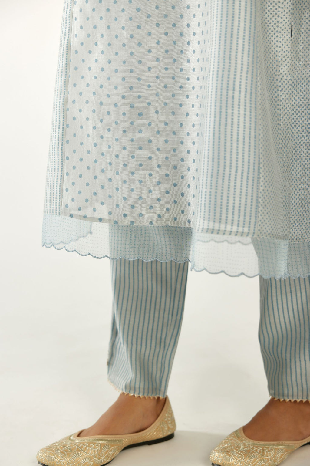 Blue silk chanderi hand block printed straight kurta set with concealed button placket neckline, highlighted with scalloped organza at edges.
