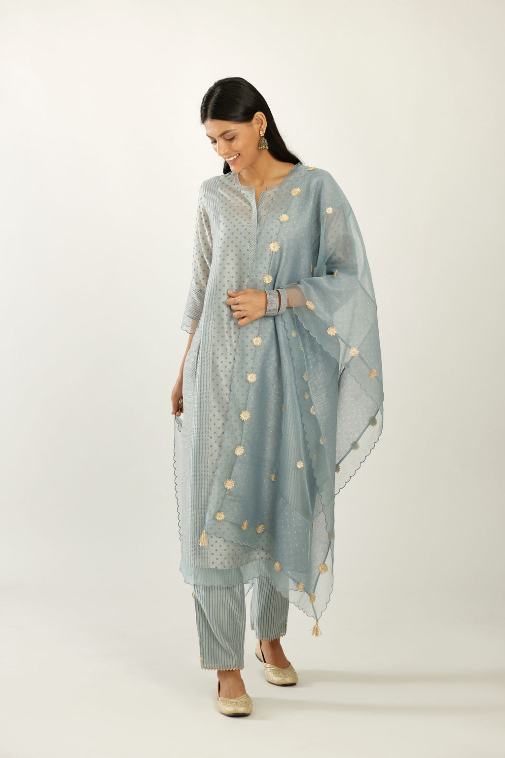 Blue silk chanderi hand block printed straight kurta set with concealed button placket neckline, highlighted with scalloped organza at edges.