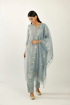 Blue silk chanderi hand block printed straight kurta set with concealed button placket neckline, highlighted with scalloped organza at edges.