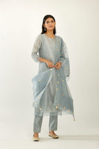Blue silk chanderi hand block printed straight kurta set with concealed button placket neckline, highlighted with scalloped organza at edges.