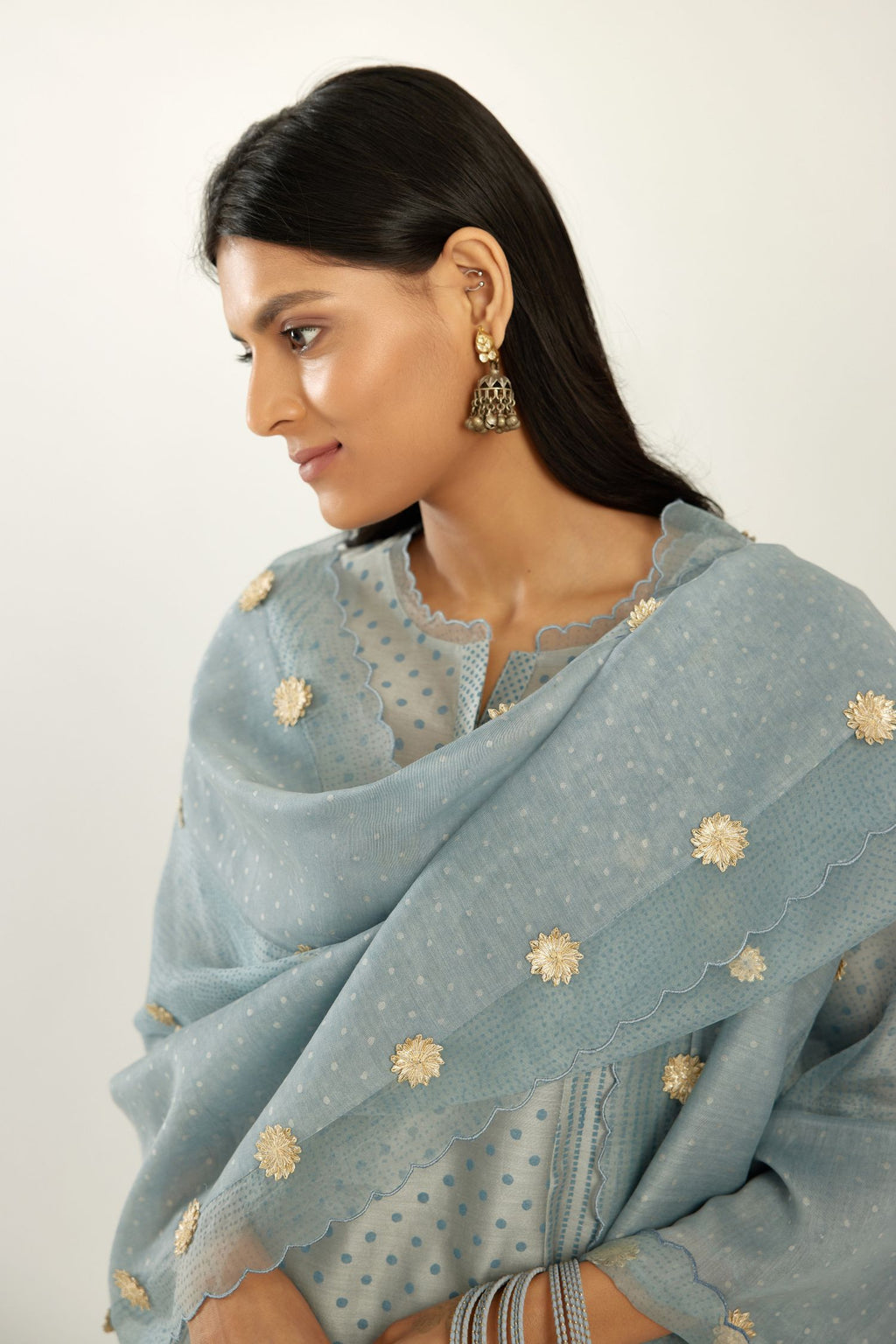 Blue silk chanderi hand block printed straight kurta set with concealed button placket neckline, highlighted with scalloped organza at edges.