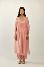 Pink hand block printed V neck gathered kurta set, highlighted with gota flower embroidery and scalloped organza at edges.