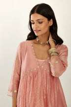 Pink hand block printed V neck gathered kurta set, highlighted with gota flower embroidery and scalloped organza at edges.
