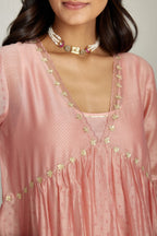 Pink hand block printed V neck gathered kurta set, highlighted with gota flower embroidery and scalloped organza at edges.