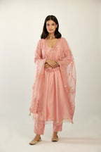 Pink hand block printed V neck gathered kurta set, highlighted with gota flower embroidery and scalloped organza at edges.