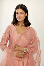 Pink hand block printed V neck gathered kurta set, highlighted with gota flower embroidery and scalloped organza at edges.