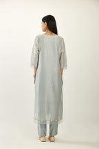 Blue hand block printed silk chanderi kurta set with concealed button placket neckline, Highlighted with gota flower and scalloped organza at edges.