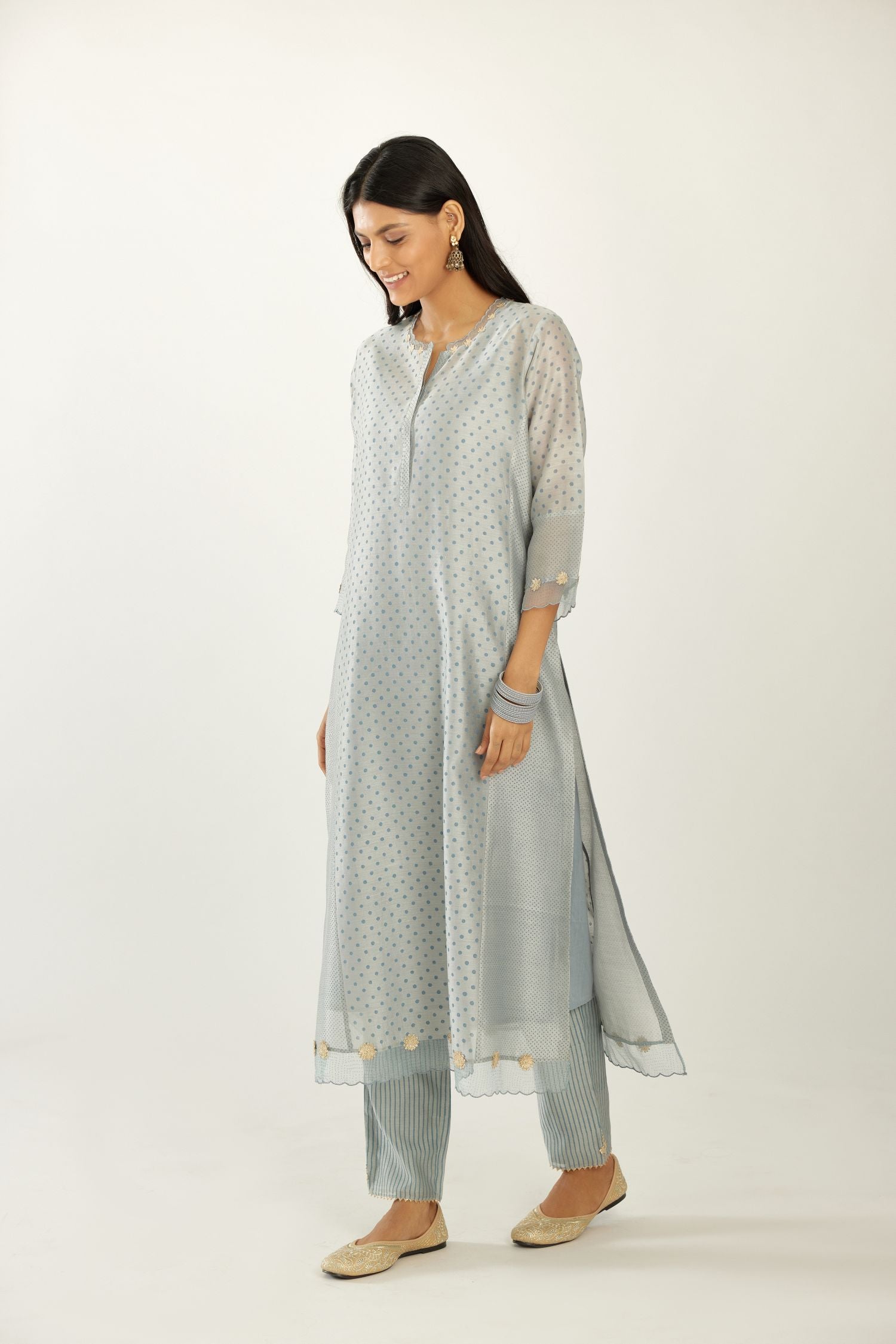 Blue hand block printed silk chanderi kurta set with concealed button placket neckline, Highlighted with gota flower and scalloped organza at edges.