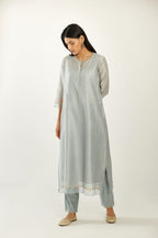 Blue hand block printed silk chanderi kurta set with concealed button placket neckline, Highlighted with gota flower and scalloped organza at edges.