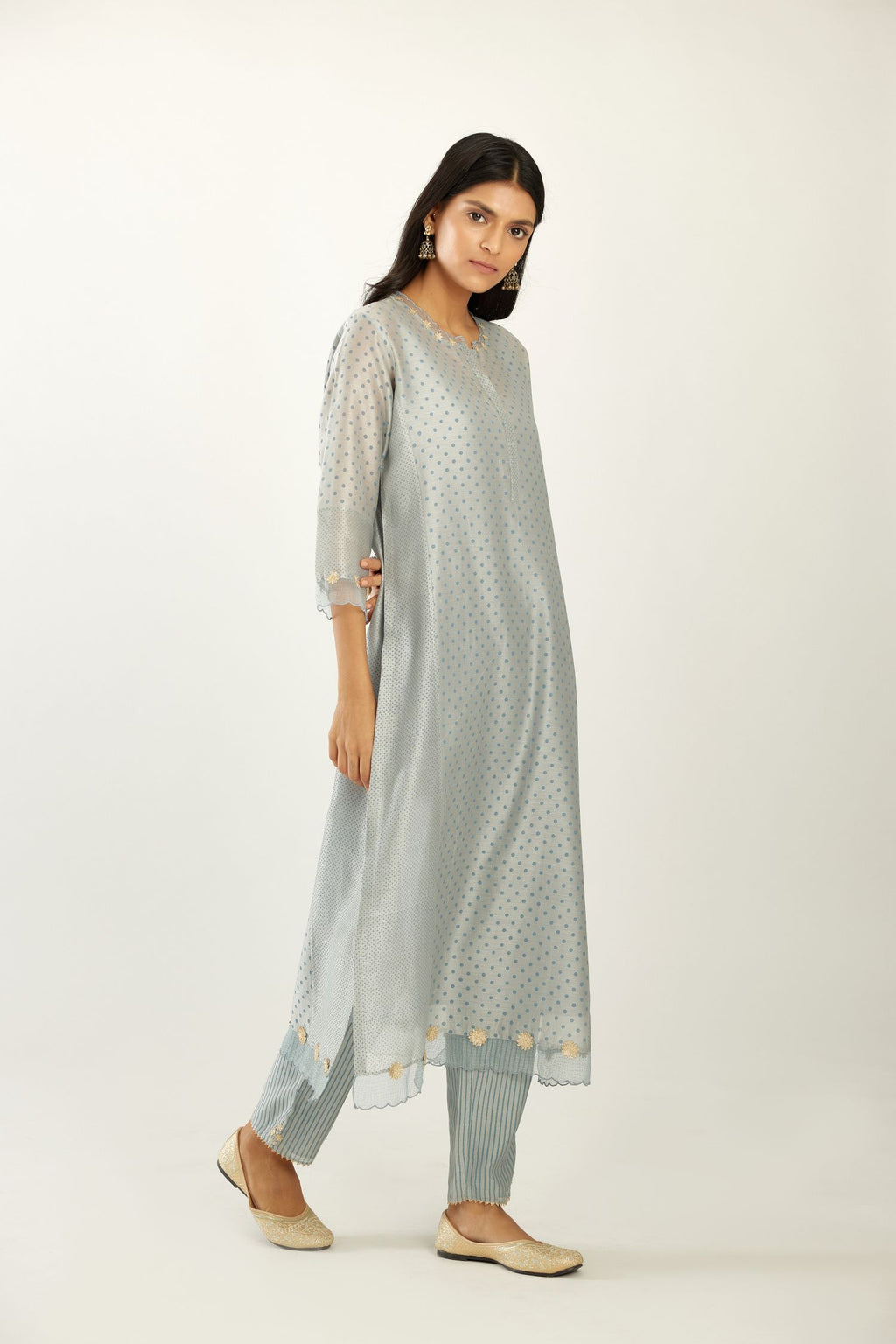 Blue hand block printed silk chanderi kurta set with concealed button placket neckline, Highlighted with gota flower and scalloped organza at edges.