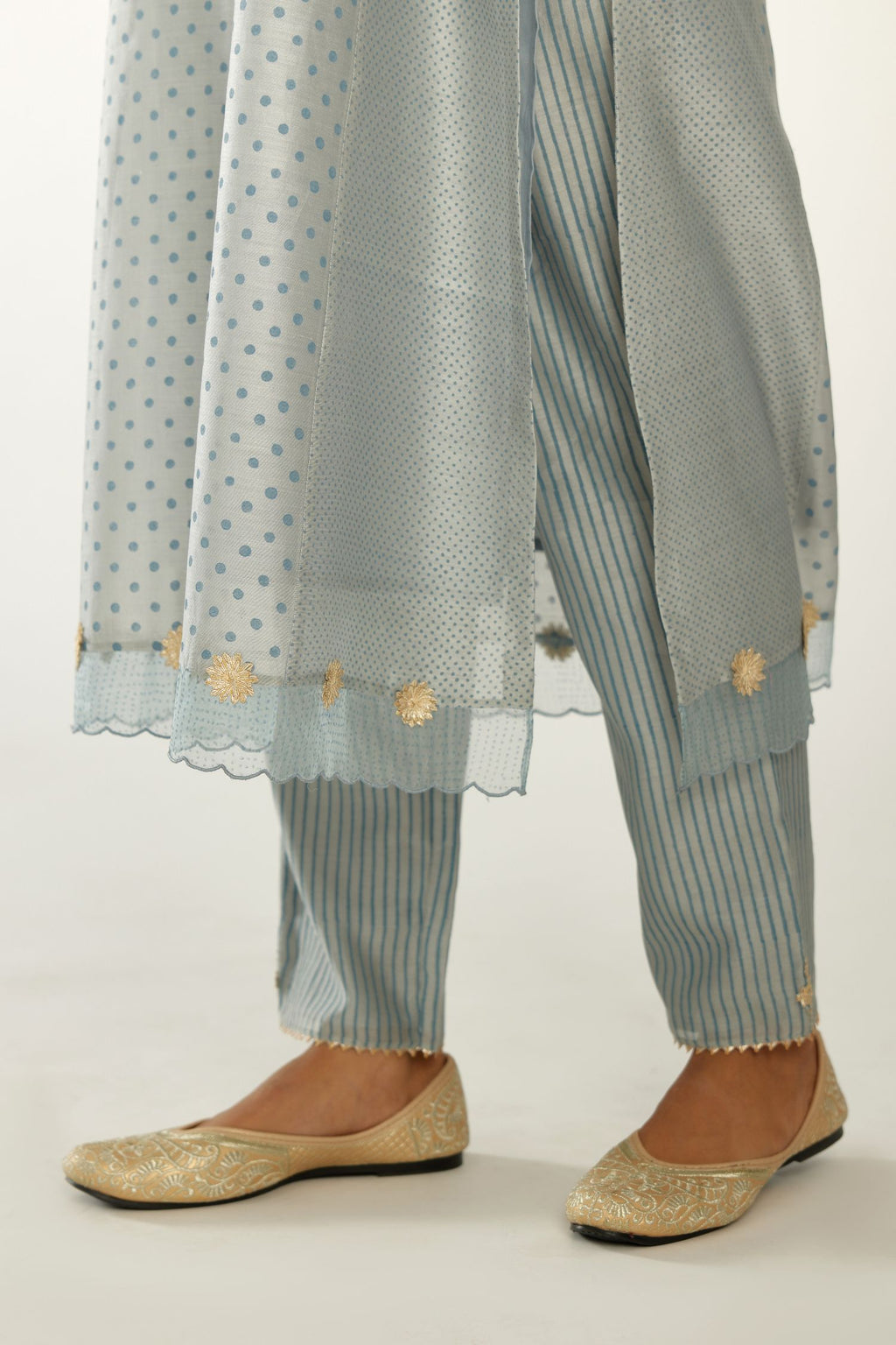 Blue hand block printed silk chanderi kurta set with concealed button placket neckline, Highlighted with gota flower and scalloped organza at edges.