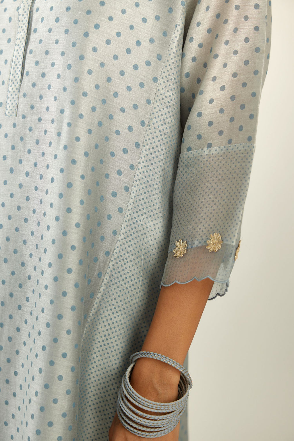Blue hand block printed silk chanderi kurta set with concealed button placket neckline, Highlighted with gota flower and scalloped organza at edges.