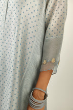 Blue hand block printed silk chanderi kurta set with concealed button placket neckline, Highlighted with gota flower and scalloped organza at edges.