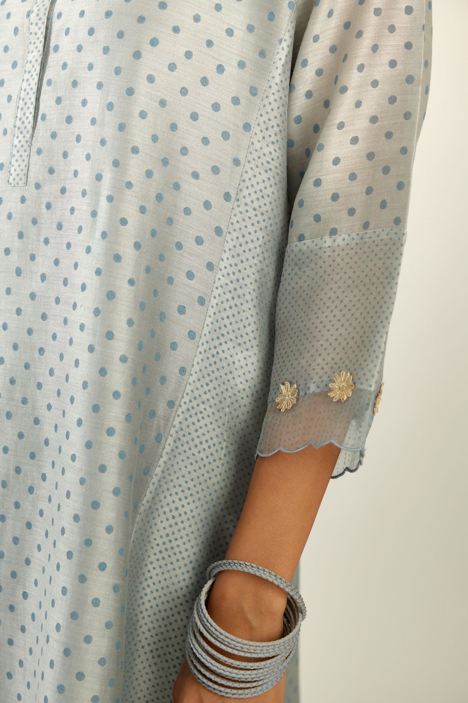 Blue hand block printed silk chanderi kurta set with concealed button placket neckline, Highlighted with gota flower and scalloped organza at edges.