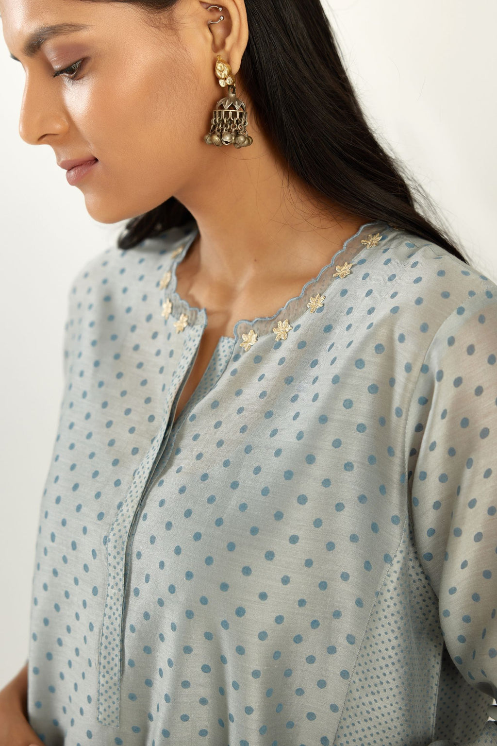 Blue hand block printed silk chanderi kurta set with concealed button placket neckline, Highlighted with gota flower and scalloped organza at edges.