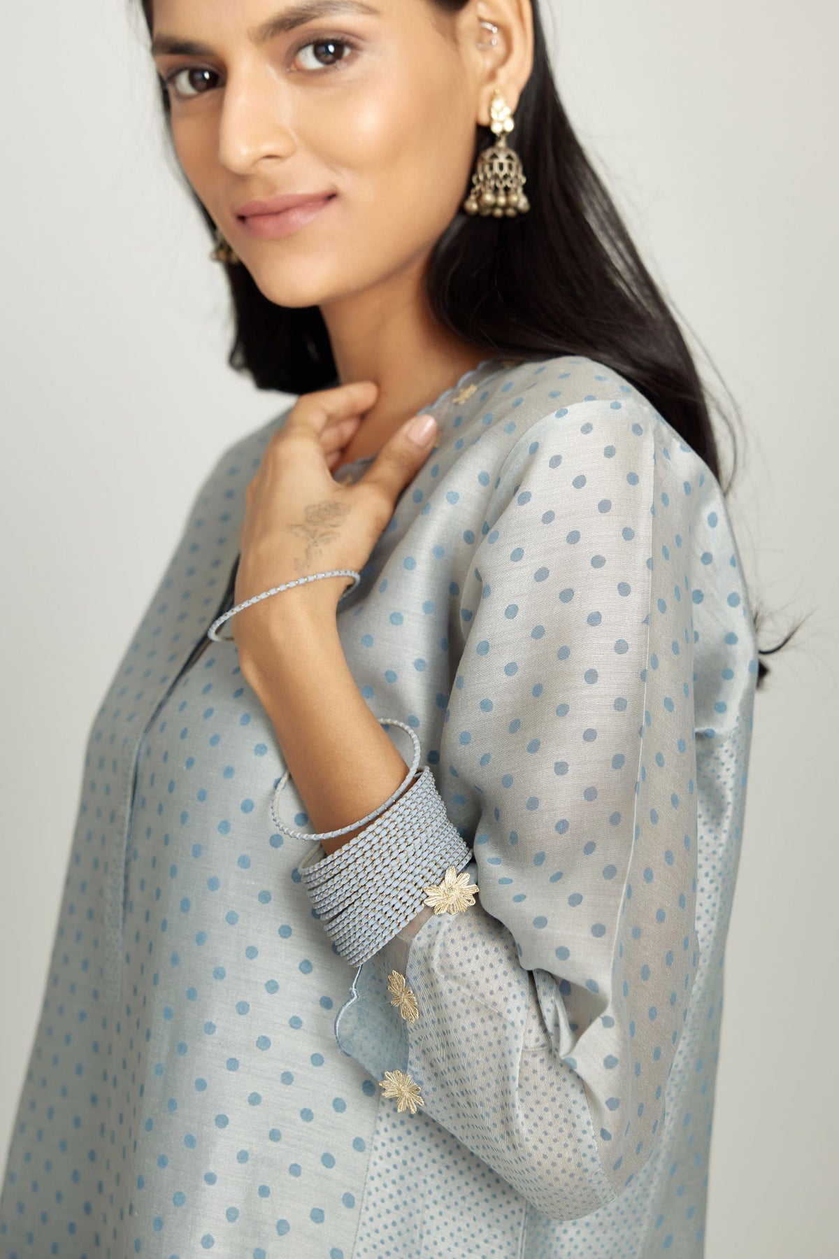 Blue hand block printed silk chanderi kurta set with concealed button placket neckline, Highlighted with gota flower and scalloped organza at edges.