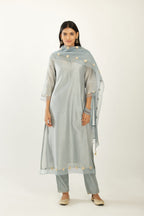 Blue hand block printed silk chanderi kurta set with concealed button placket neckline, Highlighted with gota flower and scalloped organza at edges.