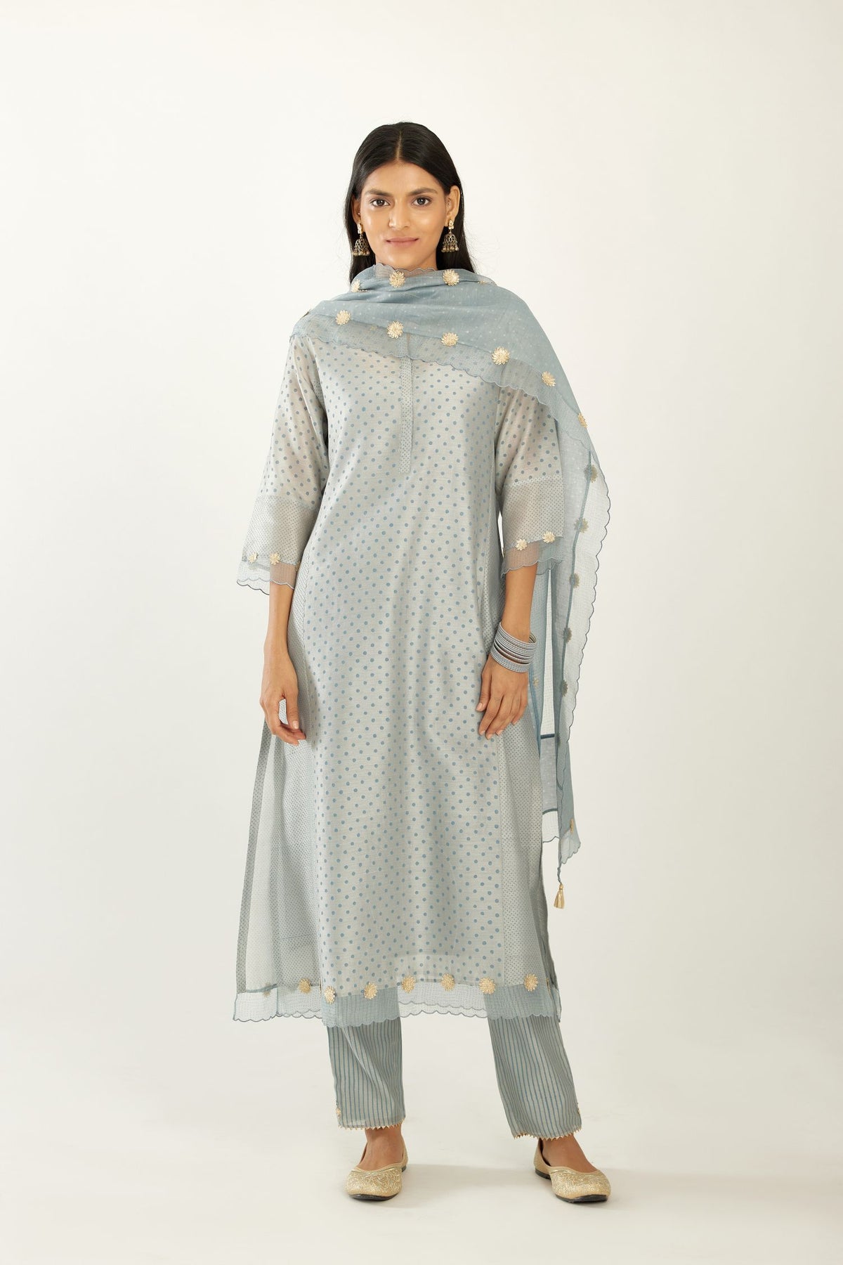 Blue hand block printed silk chanderi kurta set with concealed button placket neckline, Highlighted with gota flower and scalloped organza at edges.