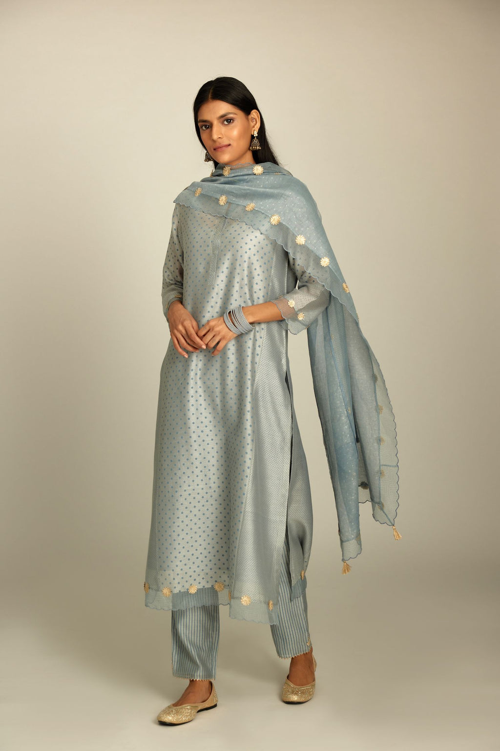 Blue hand block printed silk chanderi kurta set with concealed button placket neckline, Highlighted with gota flower and scalloped organza at edges.