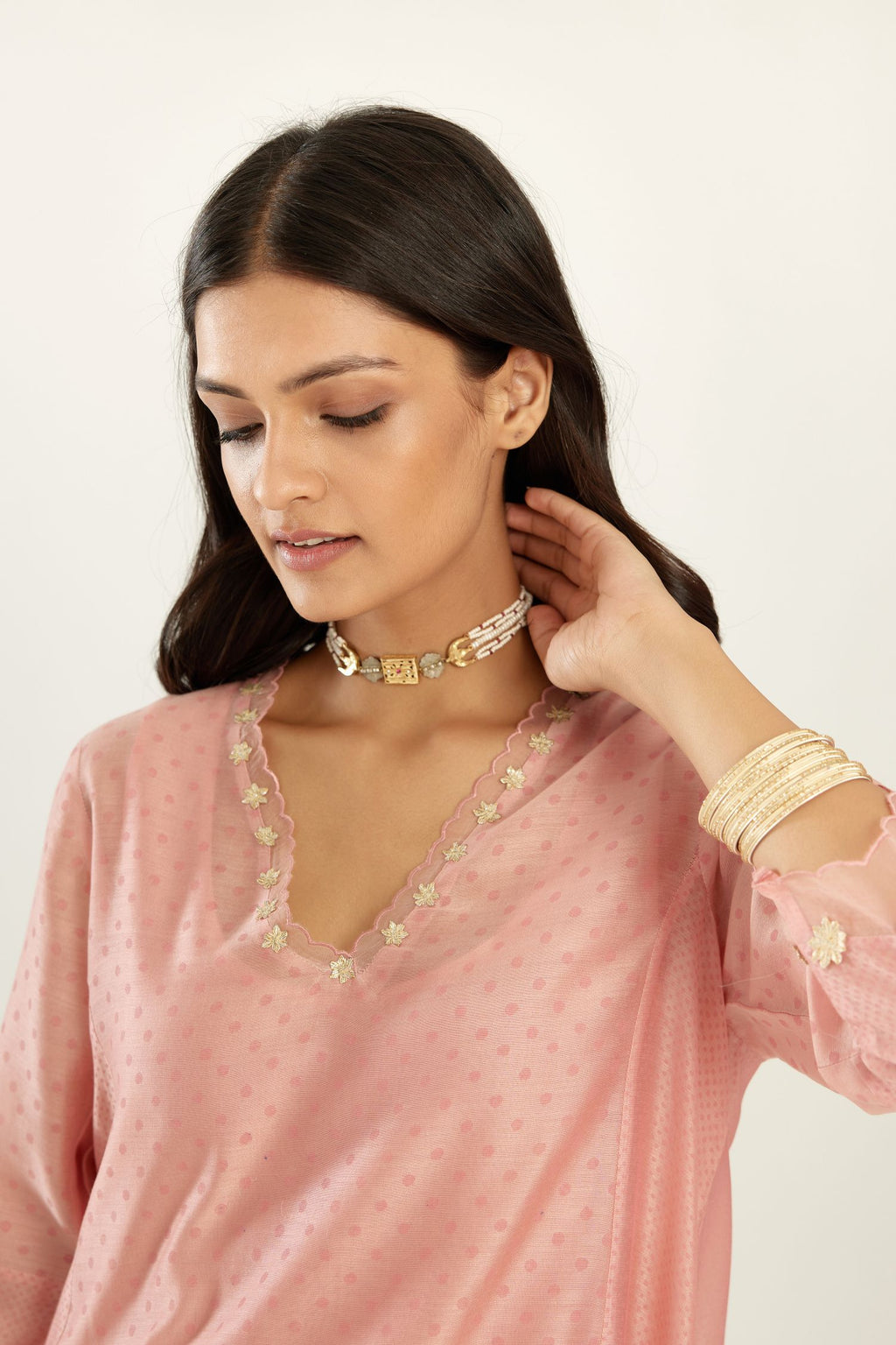 Pink A-line hand block printed silk chanderi short kurta set, highlighted with gota flower embroidery.