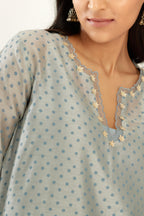Blue silk chanderi hand block printed straight kurta set, highlighted with organza and gota embroidered flower at edges
