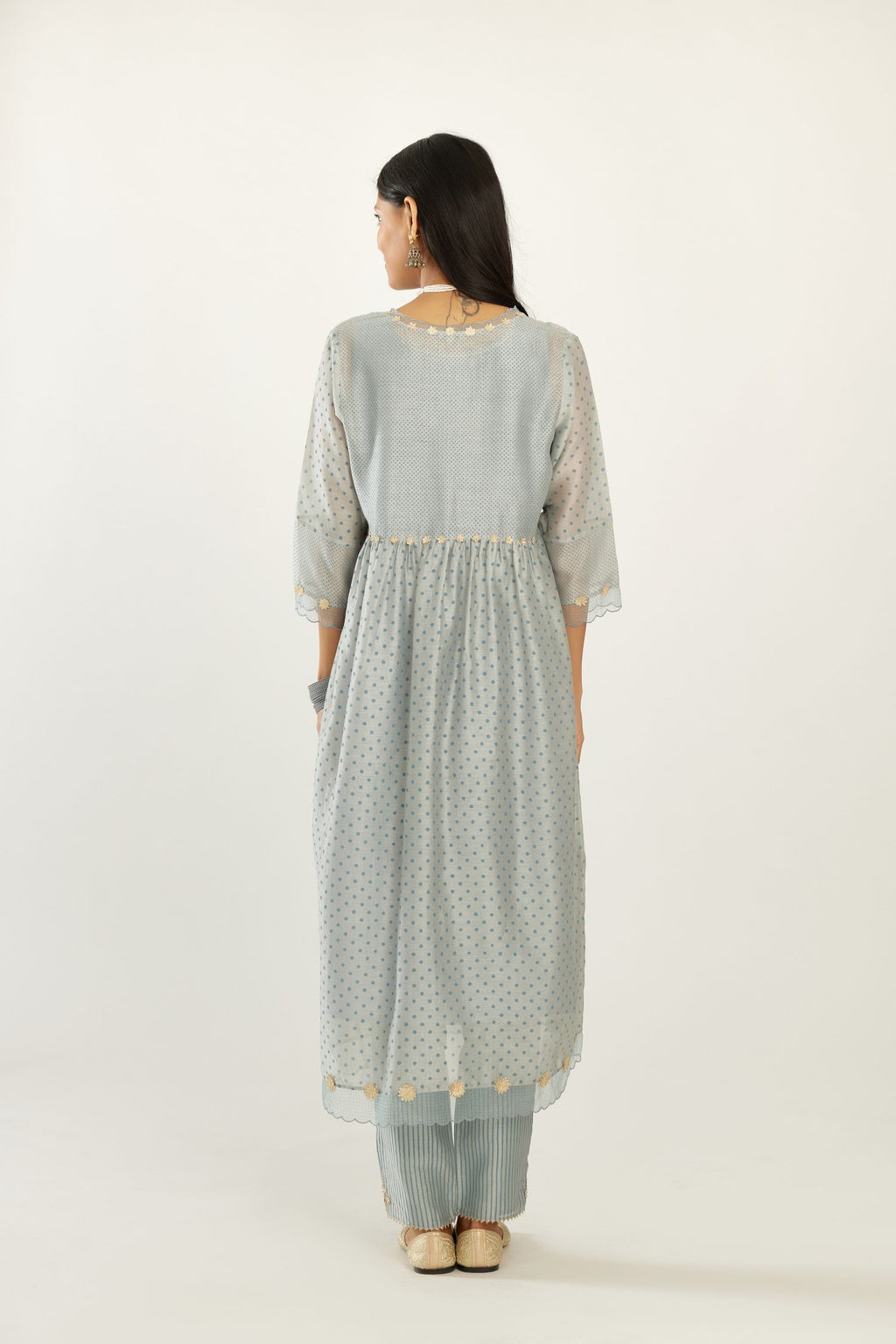 Blue hand block printed V neck gathered kurta set, highlighted with gota flower embroidery and scalloped organza at edges.