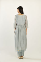 Blue hand block printed V neck gathered kurta set, highlighted with gota flower embroidery and scalloped organza at edges.