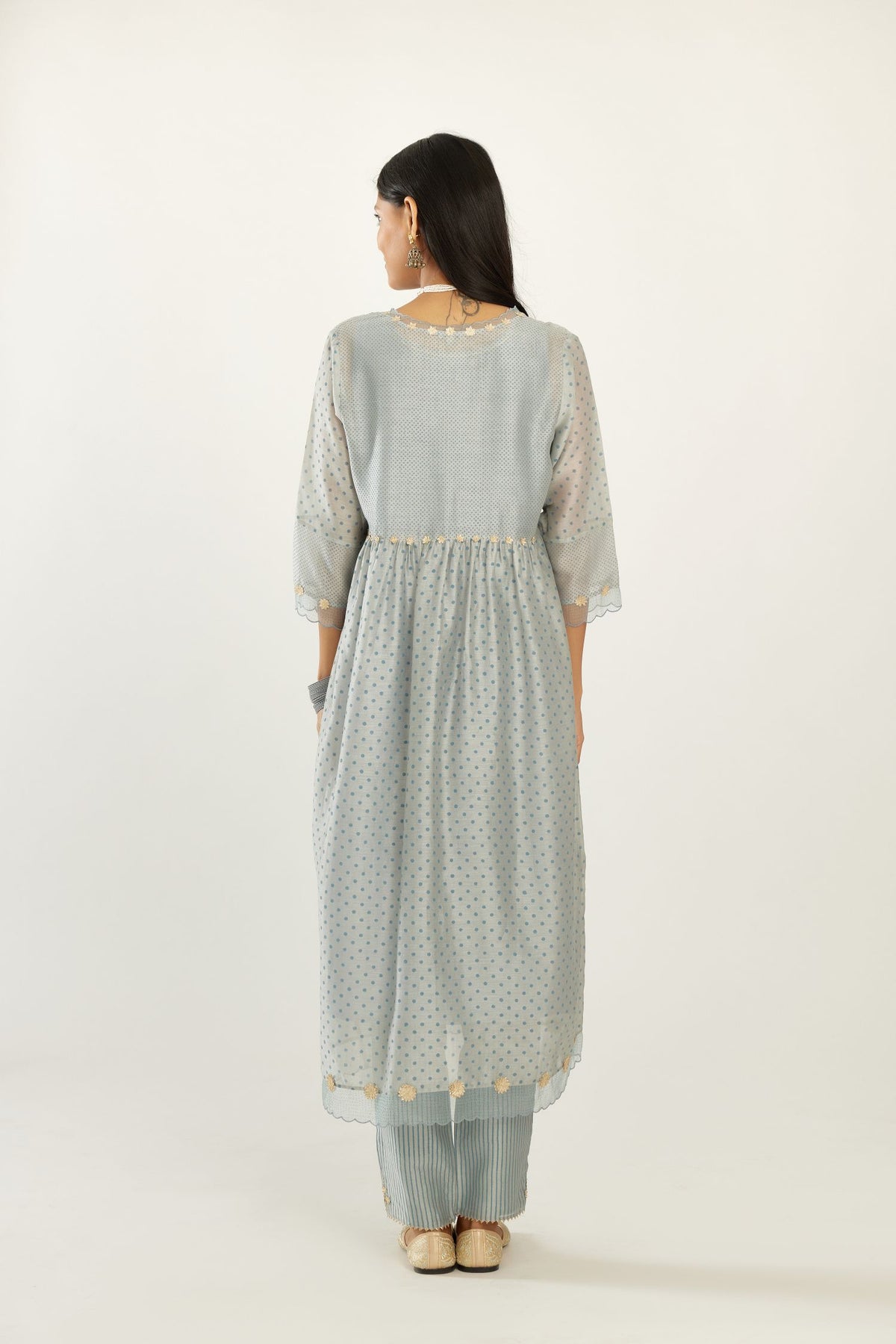 Blue hand block printed V neck gathered kurta set, highlighted with gota flower embroidery and scalloped organza at edges.