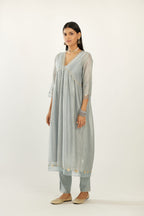 Blue hand block printed V neck gathered kurta set, highlighted with gota flower embroidery and scalloped organza at edges.