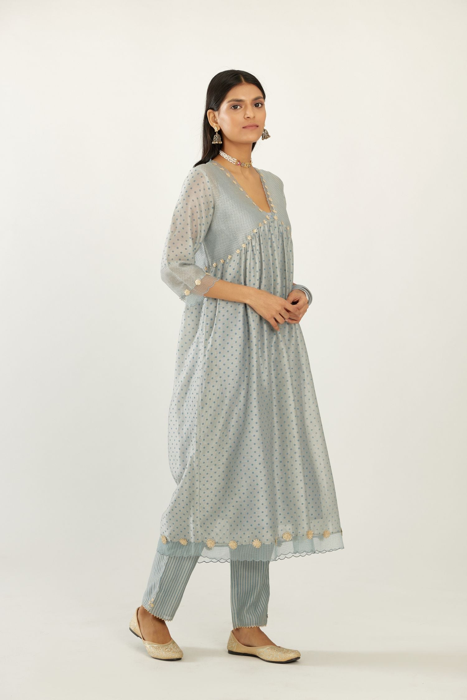 Blue hand block printed V neck gathered kurta set, highlighted with gota flower embroidery and scalloped organza at edges.