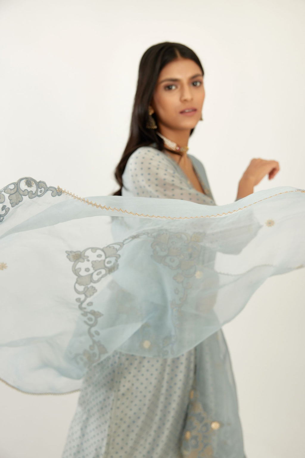 Blue hand block printed V neck gathered kurta set, highlighted with gota flower embroidery and scalloped organza at edges.