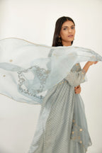 Blue hand block printed V neck gathered kurta set, highlighted with gota flower embroidery and scalloped organza at edges.