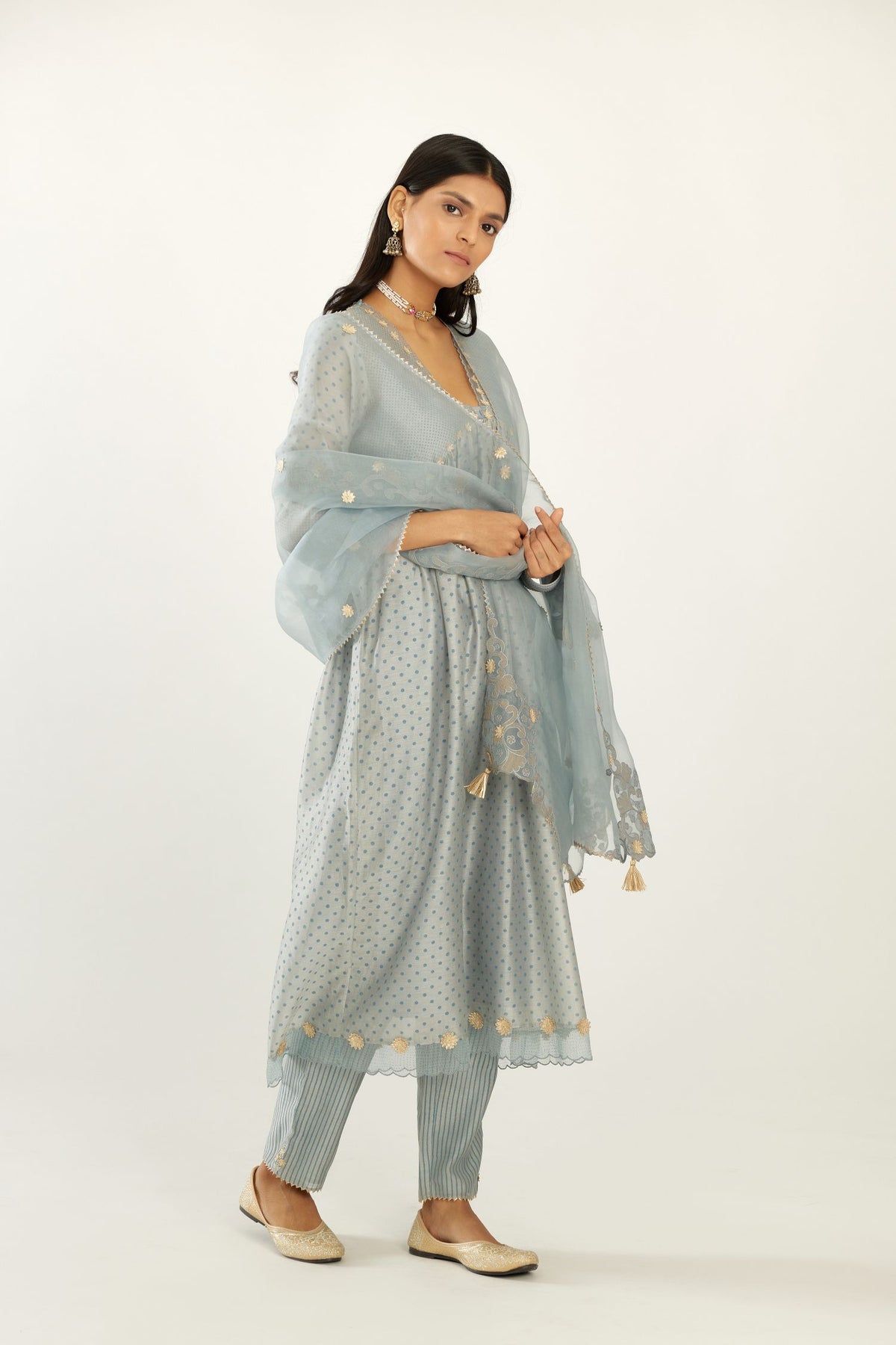 Blue hand block printed V neck gathered kurta set, highlighted with gota flower embroidery and scalloped organza at edges.