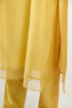 Yellow silk chanderi hand block printed straight kurta set, highlighted with scalloped organza at edges.