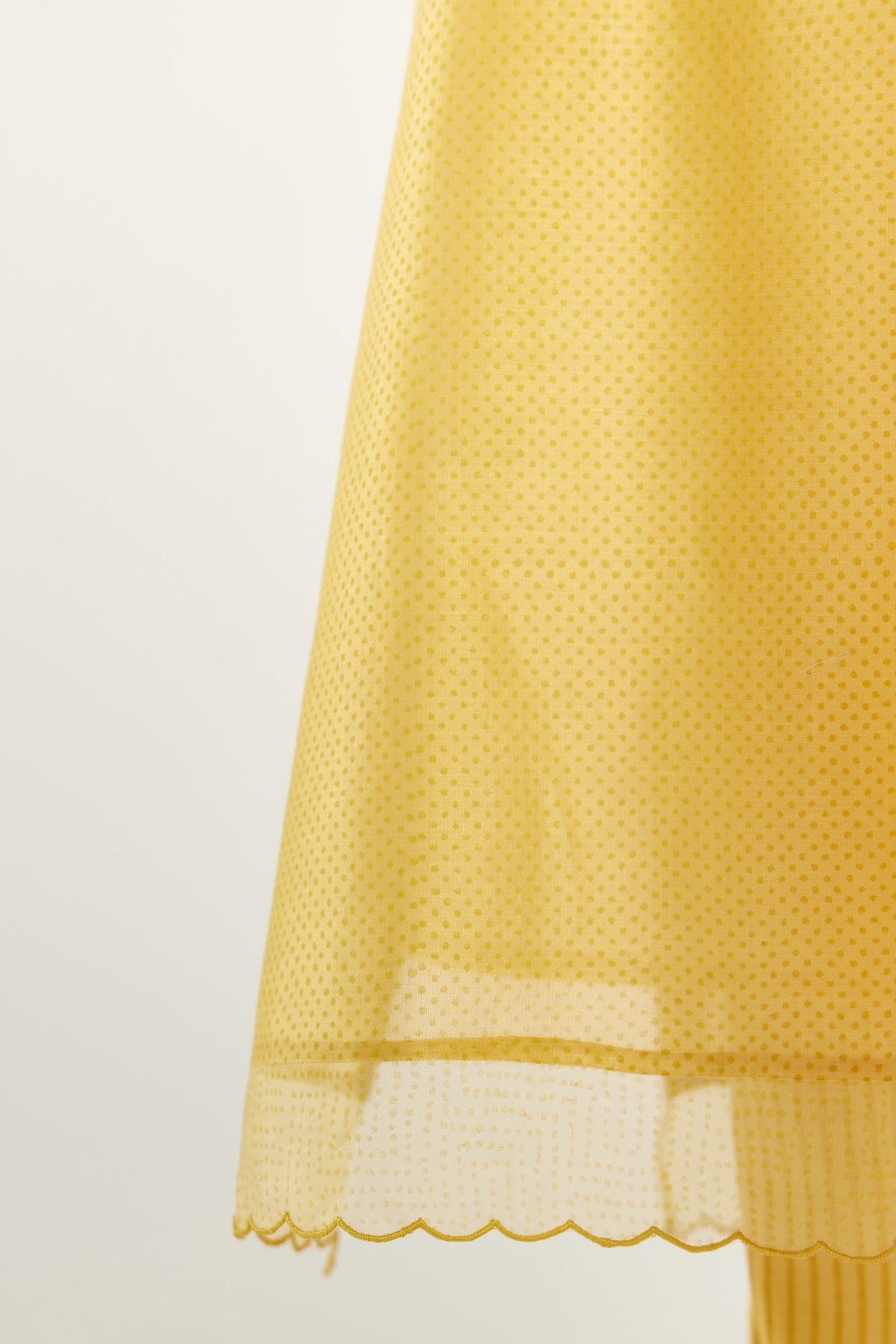 Yellow silk chanderi hand block printed straight kurta set, highlighted with scalloped organza at edges.