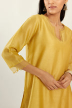 Yellow silk chanderi hand block printed straight kurta set, highlighted with scalloped organza at edges.