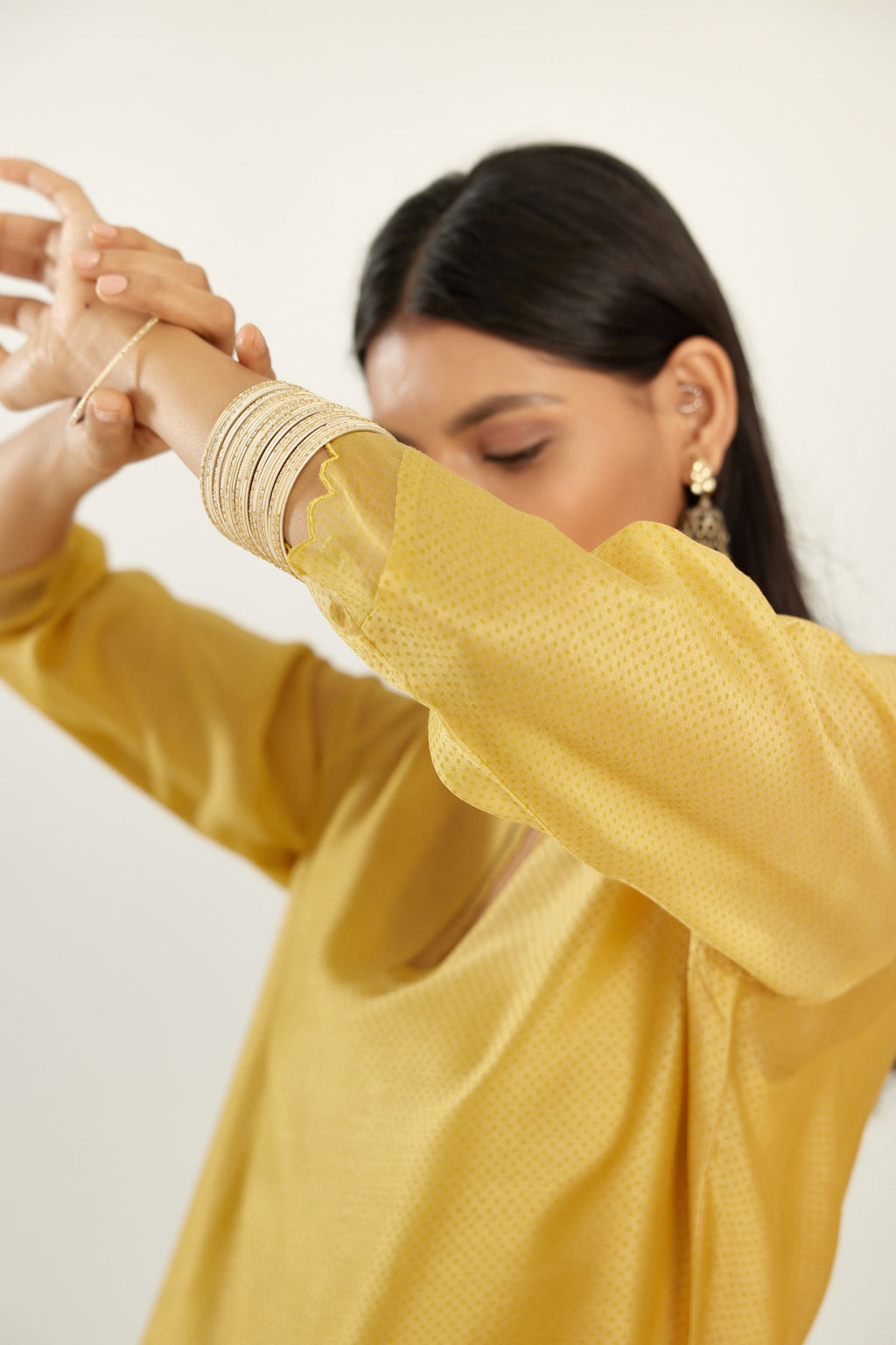 Yellow silk chanderi hand block printed straight kurta set, highlighted with scalloped organza at edges.
