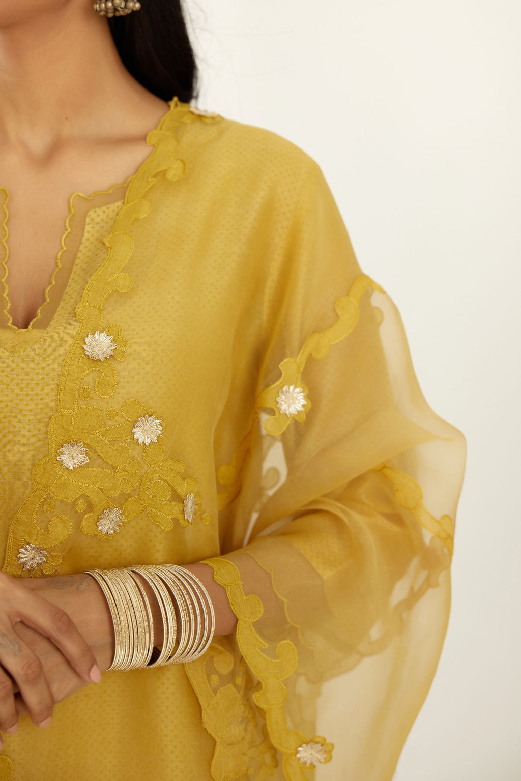 Yellow silk chanderi hand block printed straight kurta set, highlighted with scalloped organza at edges.